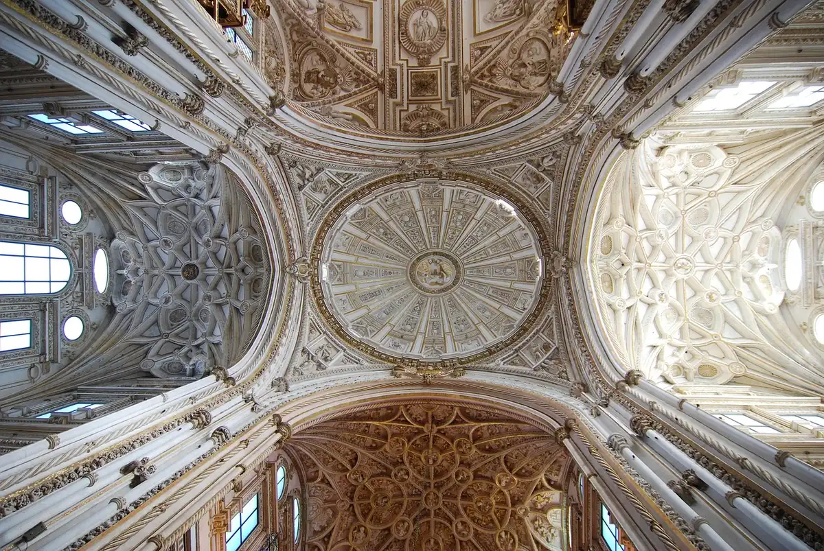 Allée de colonnes à la Mezquita-Catedral baignée de lumière