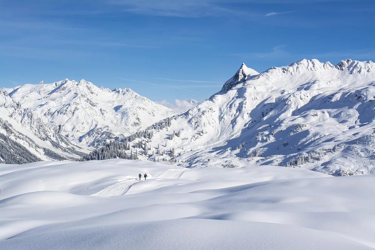 Skieurs sur une piste de ski en station du Colorado par une journée ensoleillée